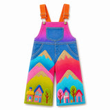 Lucky sale-Children's overalls featuring a colorful pattern of trees, houses, and mountains.
